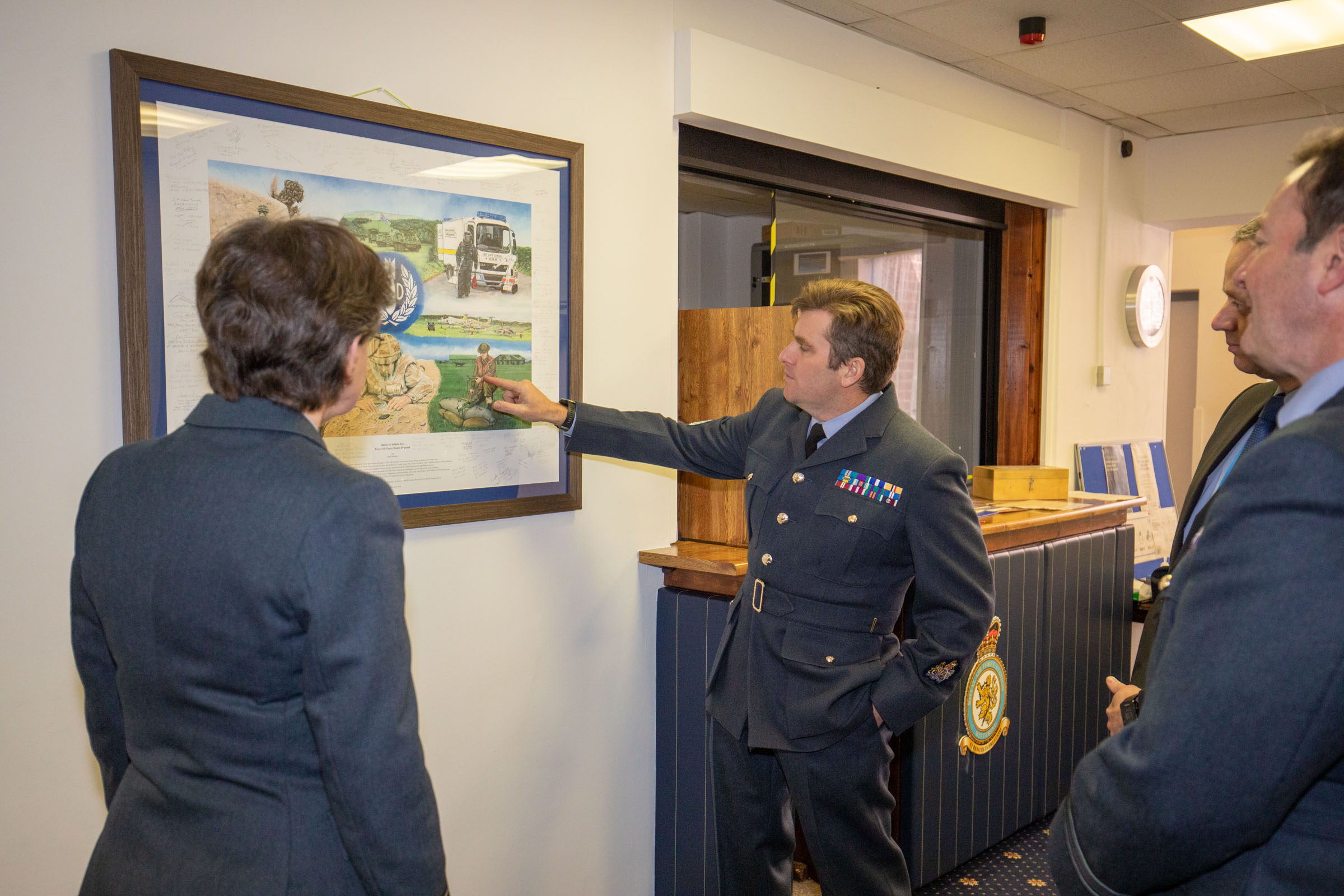 Warrant Officer Lowe explains some of the historical details in the painting